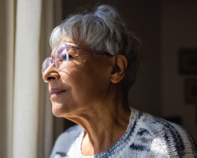 Elderly woman looking out a window