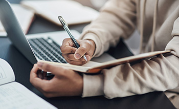 Male hands writing in a notebook